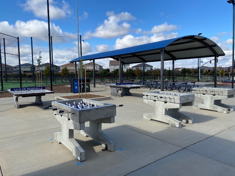 Permanent outdoor ping pong and foosball tables in the public park in Roseville Ca. Outdoor concrete game tables in public park